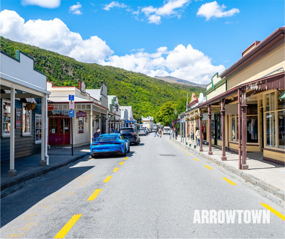 Scenic view of Arrowtown, New Zealand, showcasing its charming historic buildings, vibrant autumn colors, and picturesque landscape.