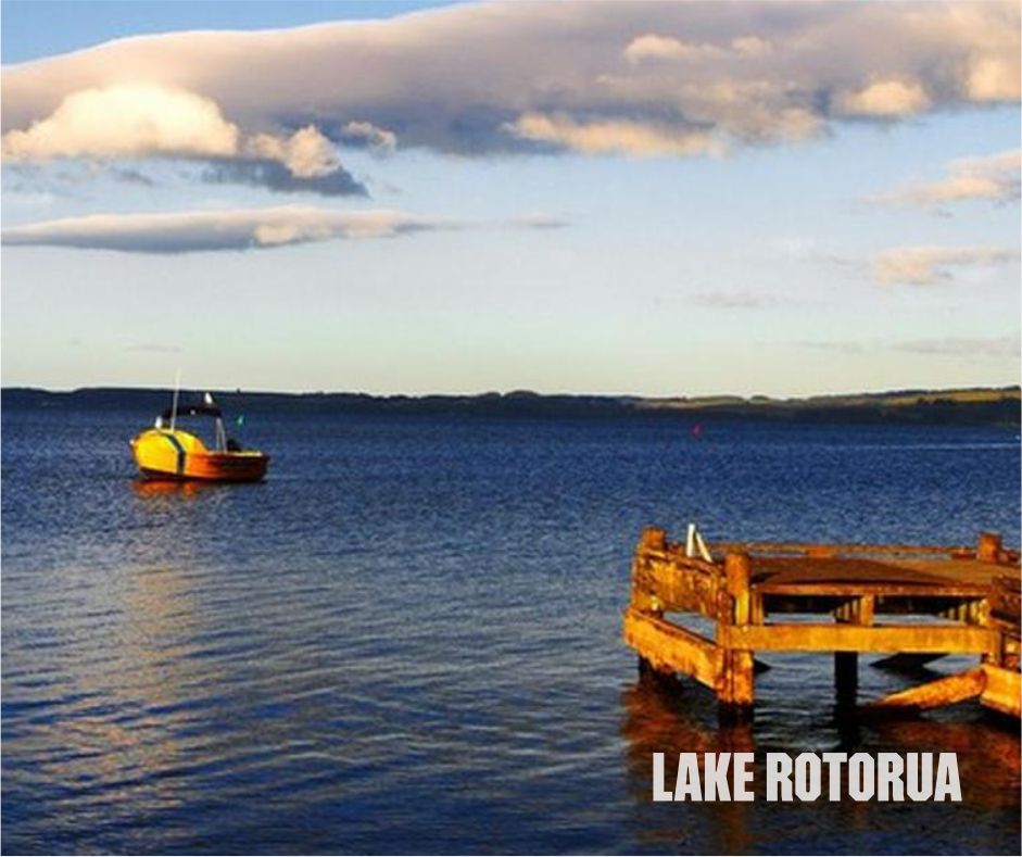 Scenic view of Lake Rotorua in New Zealand with lush landscapes, clear blue waters, and surrounding mountains, showcasing the natural beauty of the region, New Zealand group tour from Jaipur, New Zealand group tour from Vadodara