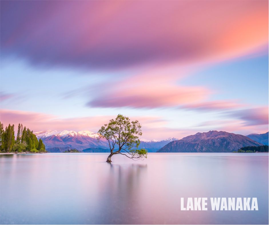 Stunning view of Lake Wanaka in New Zealand, showcasing crystal-clear waters surrounded by snow-capped mountains and lush greenery, a perfect destination for nature lovers and adventure seekers.